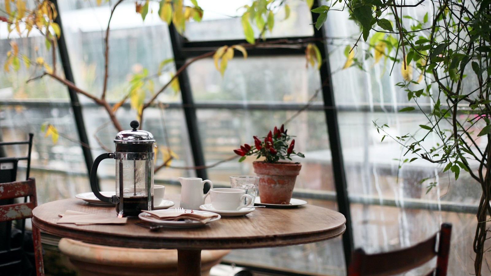 Wooden tabletop with coffee cup and café atmosphere, bright lived-in feel